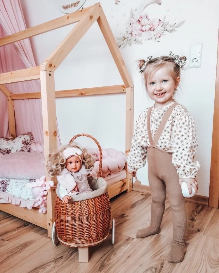 Luke wicker push-along doll pram with pink trim, handle and wooden wheels TheWickerStories