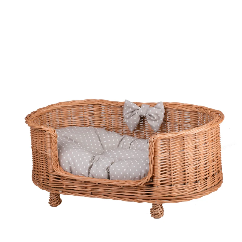 Esoria wicker pet bed for dogs and cats with a beige cushion, elevated on legs with a low entry TheWickerStories