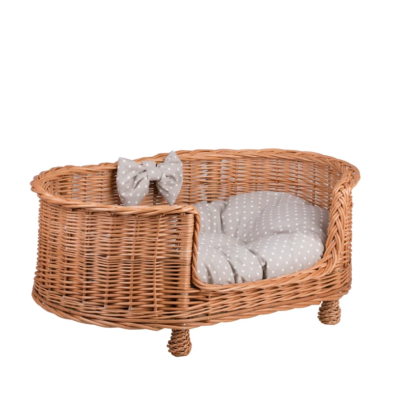 Esoria wicker pet bed for dogs and cats with a beige cushion, elevated on legs with a low entry TheWickerStories