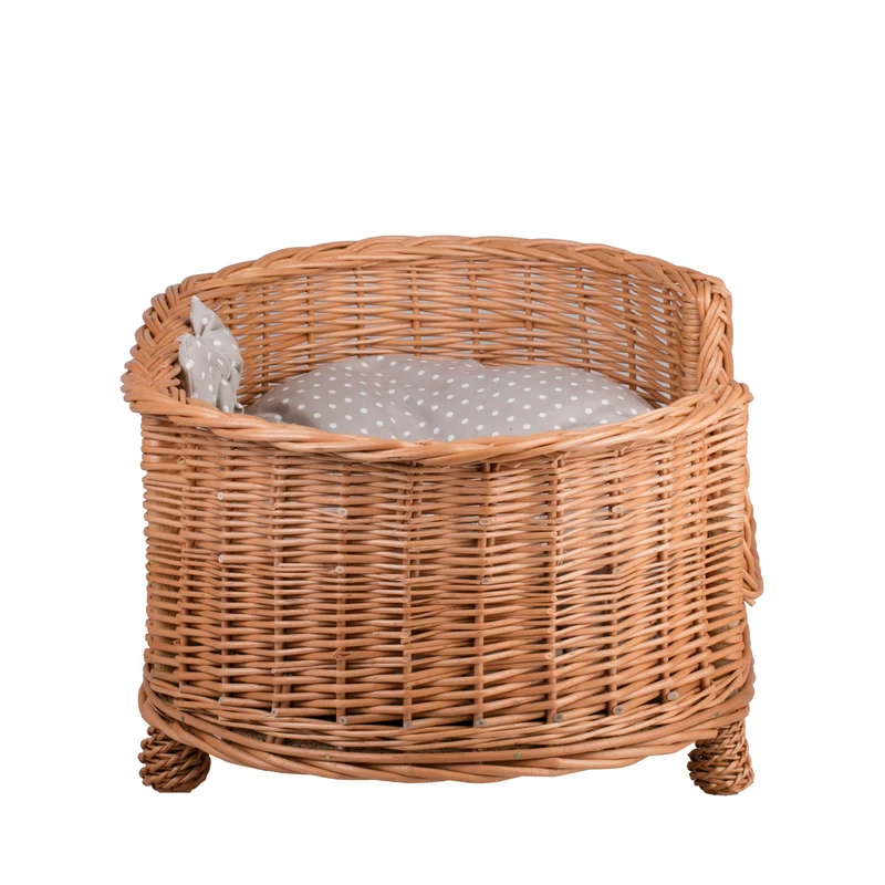 Esoria wicker pet bed for dogs and cats with a beige cushion, elevated on legs with a low entry TheWickerStories