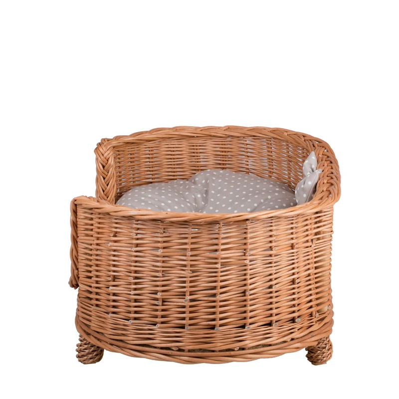 Esoria wicker pet bed for dogs and cats with a beige cushion, elevated on legs with a low entry TheWickerStories