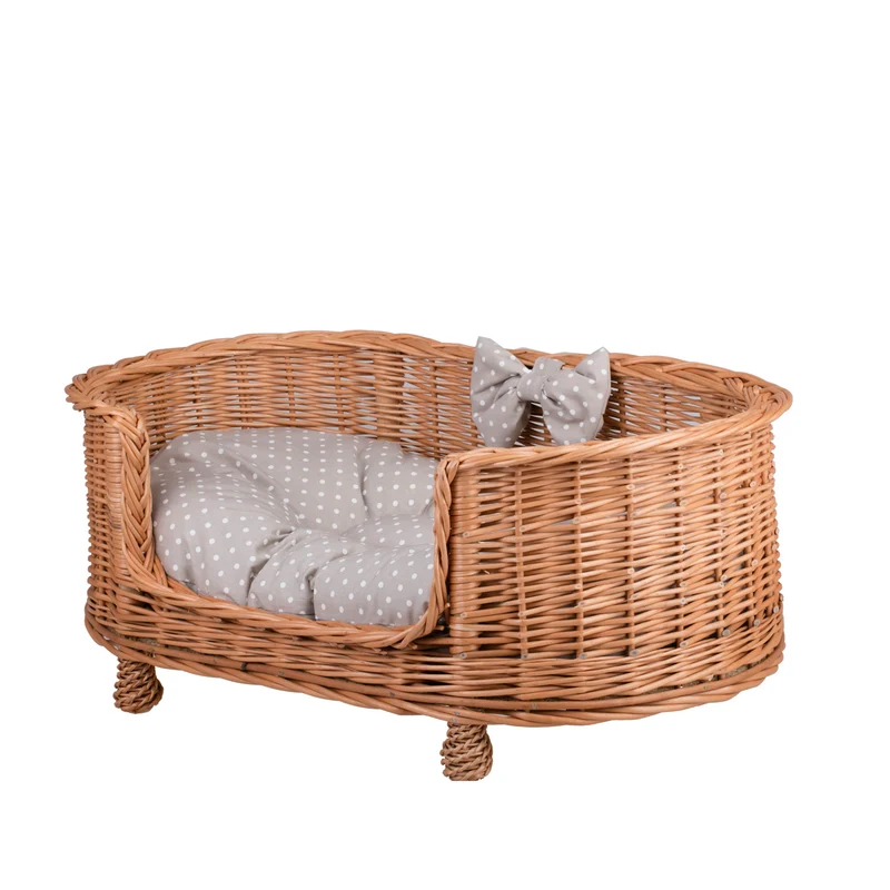 Esoria wicker pet bed for dogs and cats with a beige cushion, elevated on legs with a low entry TheWickerStories