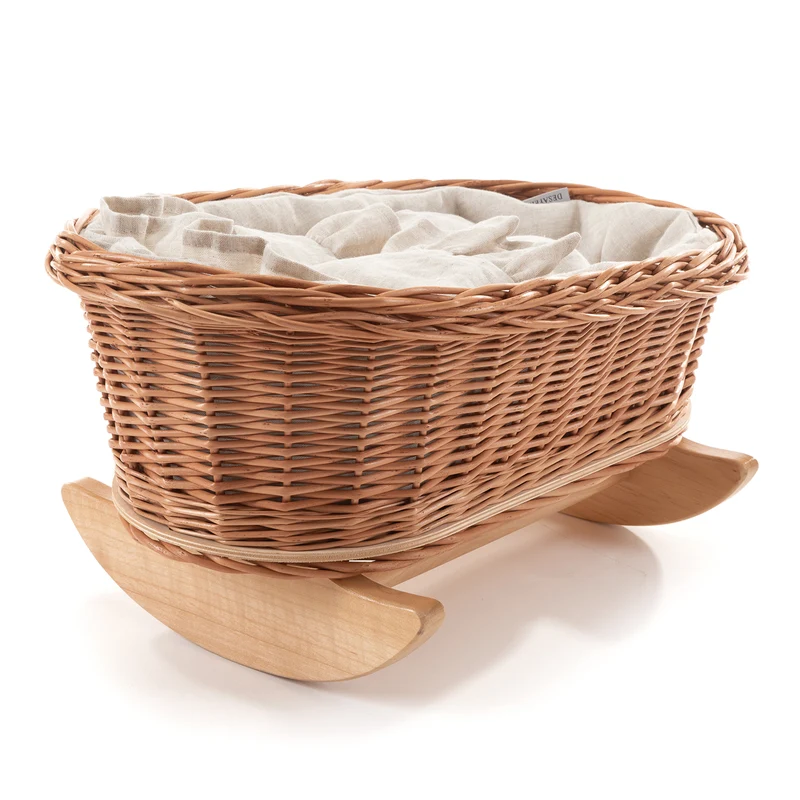 Desayerwiklinowa wicker doll cradle with white trim, pillow and quilt on beech rockers TheWickerStories