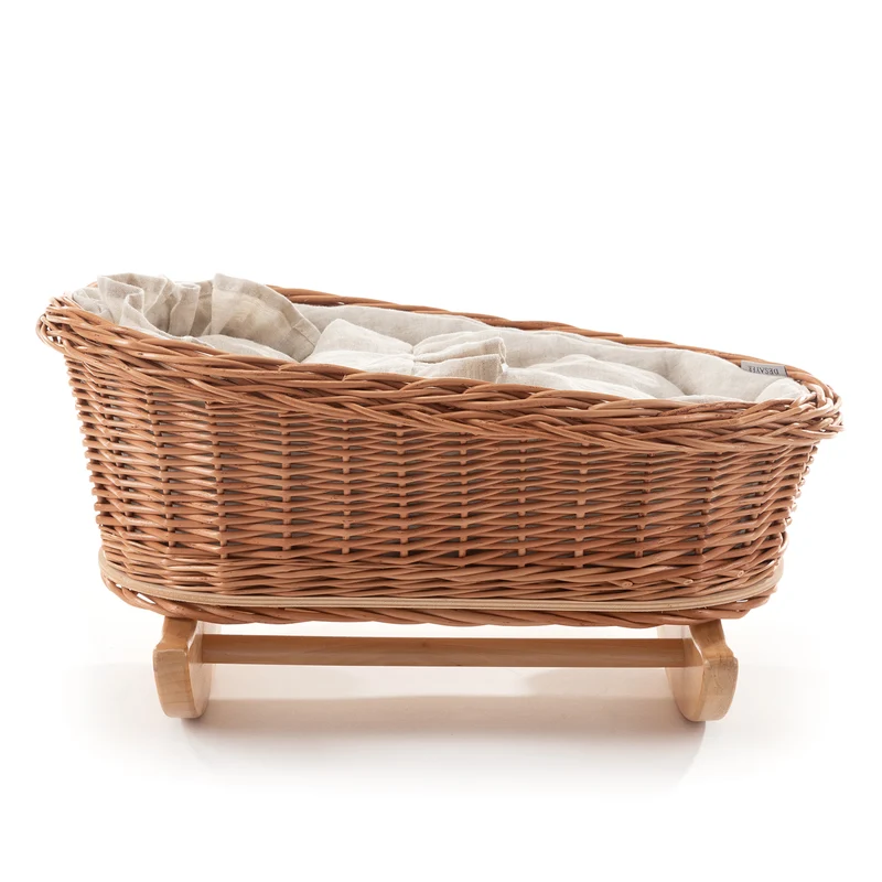 Desayerwiklinowa wicker doll cradle with white trim, pillow and quilt on beech rockers TheWickerStories