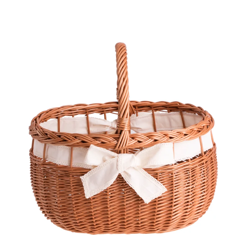 Winalia wicker shopping basket with cream trim, handle, and bow TheWickerStories