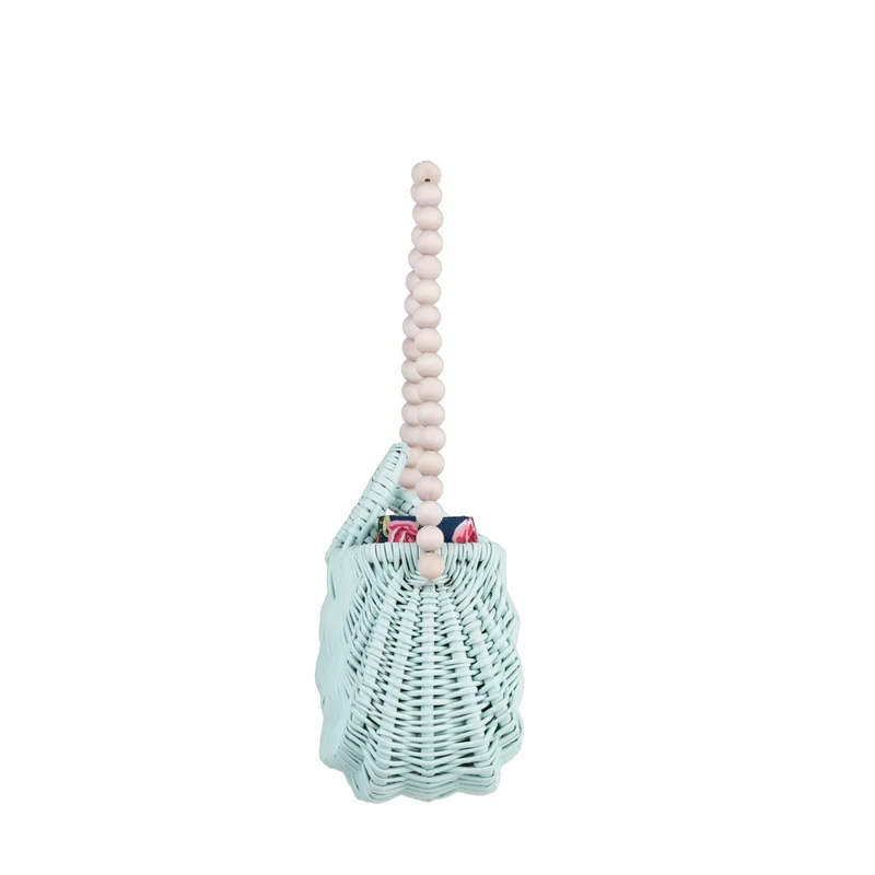 Werlissa wicker beach bag with navy trim, featuring handles and a strap made of wooden beads TheWickerStories