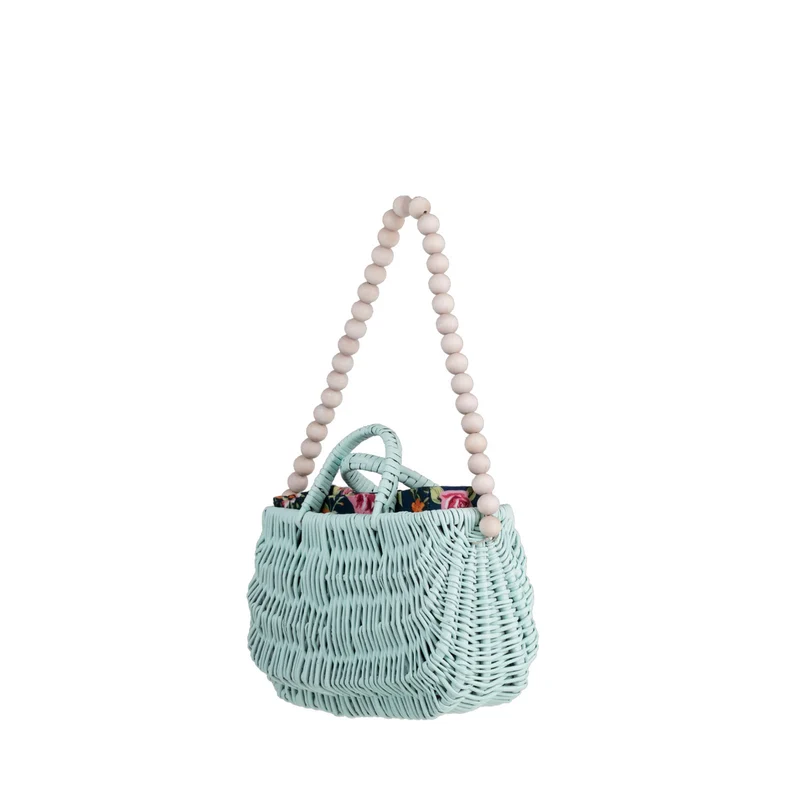 Werlissa wicker beach bag with navy trim, featuring handles and a strap made of wooden beads TheWickerStories